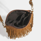 Interior da bolsa crossbody de camurça caramelo aberto, mostrando os compartimentos e o zíper