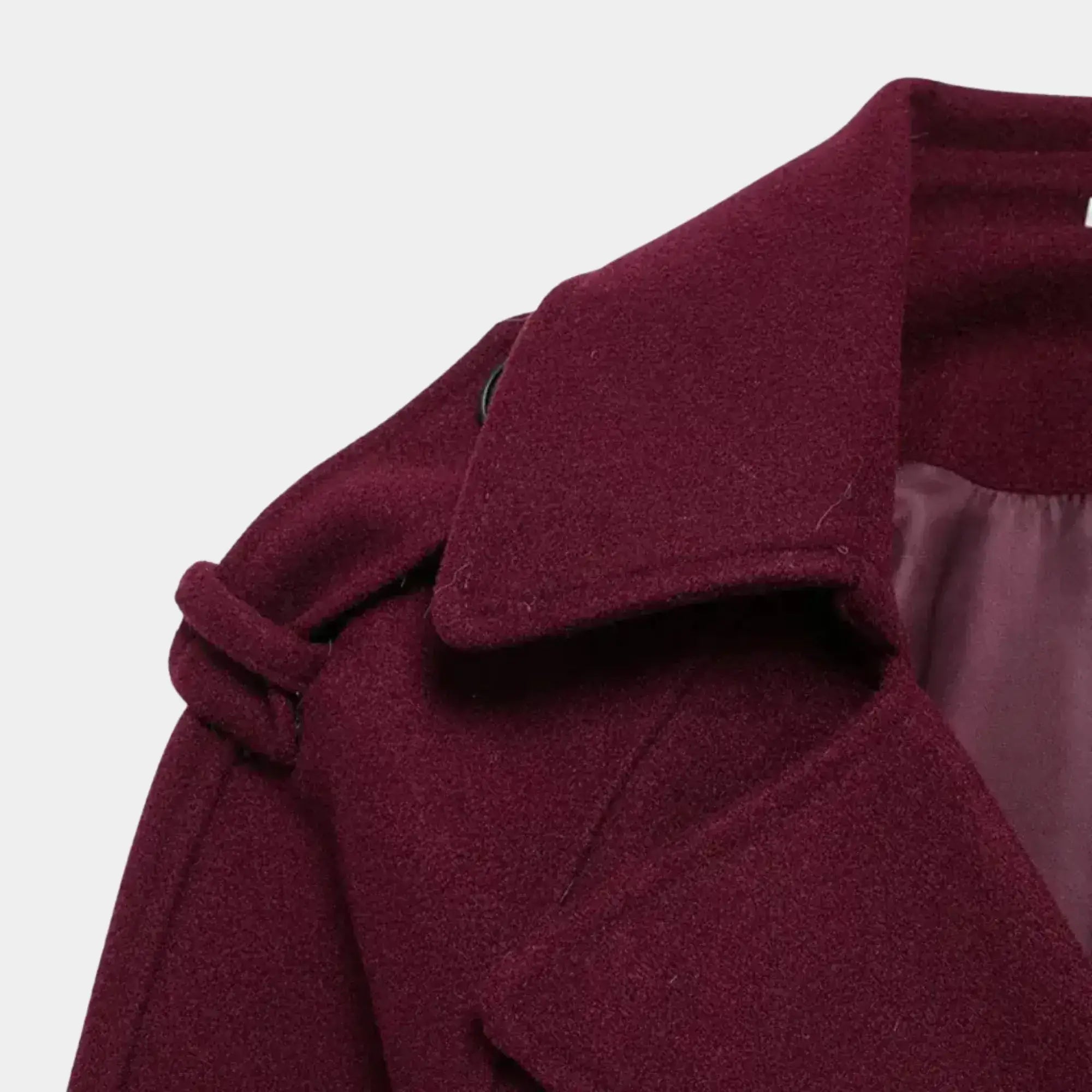 Detalhe da gola ampla e ombreira do trench coat feminino longo vinho com acabamento premium e tecido encorpado